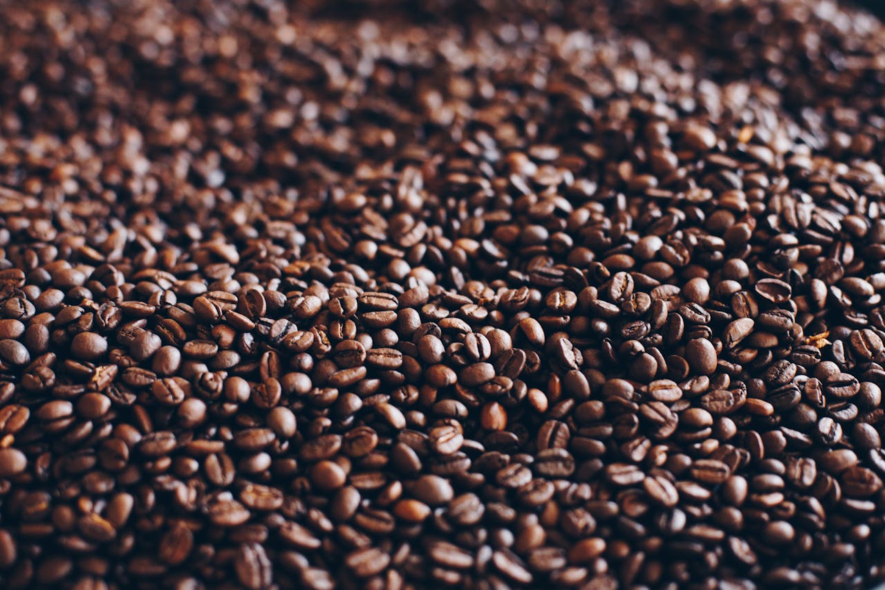 team-04 Close-up view of aromatic roasted coffee beans, perfect for caffeine lovers.